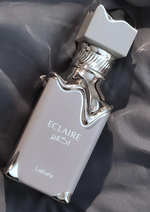 Eclaire by Lattafa Perfumes is a Floral Fruity Gourmand fragrance for women. This is a new fragrance. Eclaire was launched in 2024. Top notes are Caramel, Milk and Sugar; middle notes are Honey and White Flowers; base notes are Vanilla, Praline and Musk.